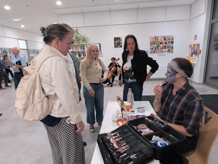 Gäste verfolgen die Gesichtsmalerei von Starbuck Friend alias Penelope Ness